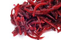 a pile of grated beet on a white background